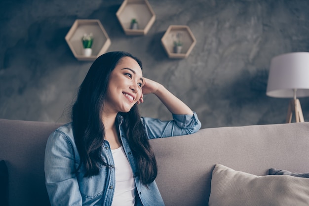 girl sitting on sofa looking to window