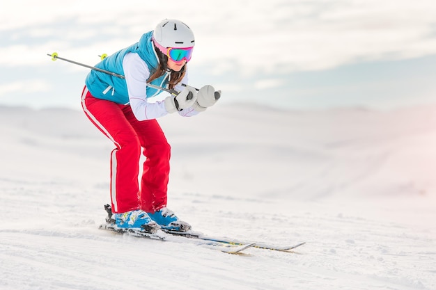 Girl skier in downhill position