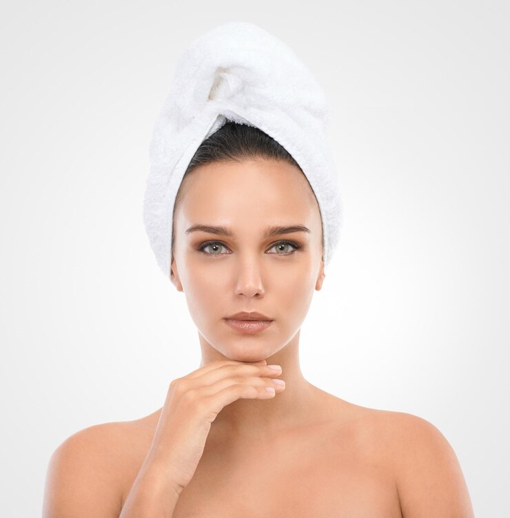 Photo girl skincare and face in studio with towel for natural look cosmetics and dermatology for wellness woman portrait and clean for self care mockup and white background with serious model