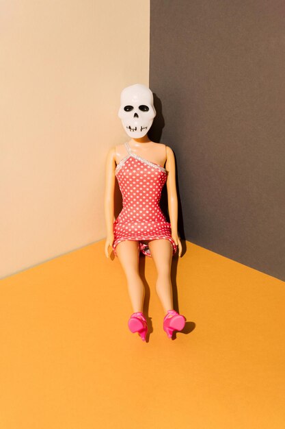 Girl in skull costume is sitting in the corner of the room Halloween party minimal concept