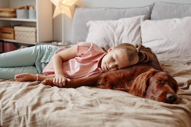 Girl Sleeping with Dog on Bed