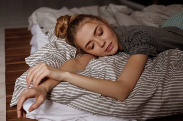 girl sleeps in the bed at home. blurred space. large portrait