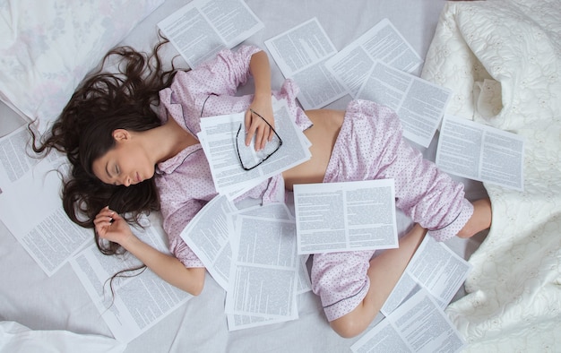 Girl sleeps in a white bed at home