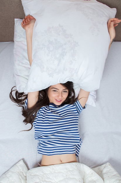 Girl sleeps in a white bed at home