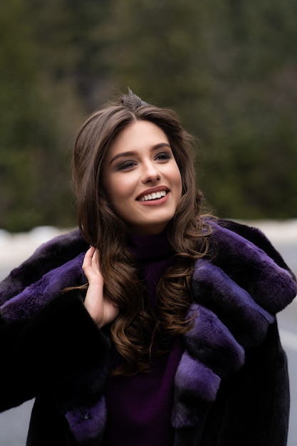 Girl smiling at camera on winter woods