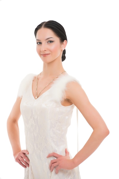 Girl on smiling face dressed in luxury dress with fur posing with posture. Dancer of ballroom dance looks gorgeous. Dancer of ballroom dance stands with hands on hips. Posture and elegancy concept.