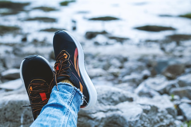 Girl in sneakers resting by the river