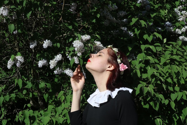 Girl sniffing a flowers in the garden