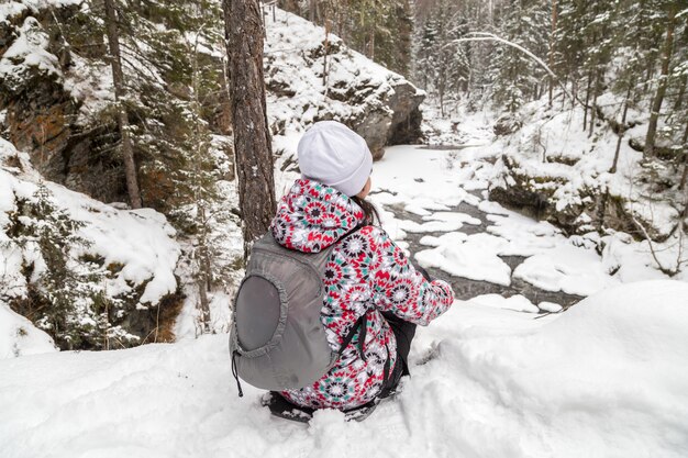 Girl on snow forest