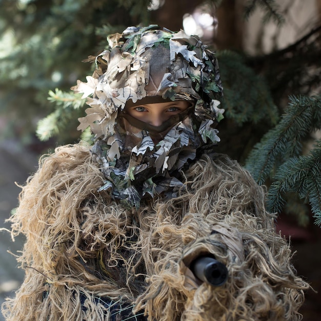 Girl soldier in ghillie camouflage