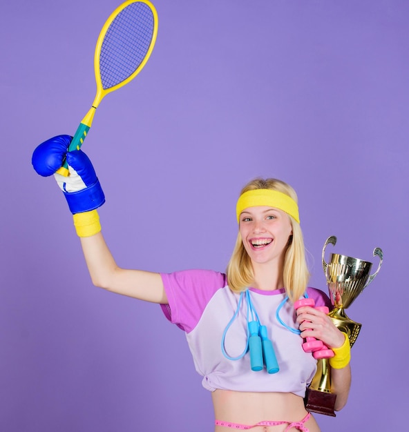 Girl sport instructor hold golden goblet of winner or champion Woman good in tennis jumping boxing fitness sport She is best in all competitions Sport champion Fitness champion Champion concept