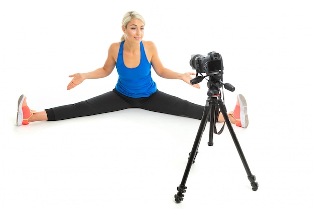 Girl in sportswear doing sports in front of the camera on white