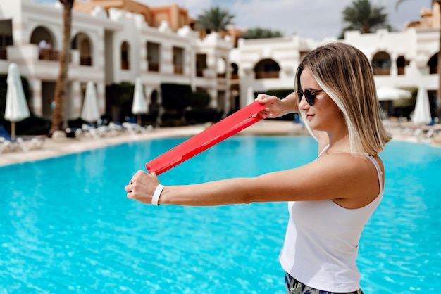 Girl in sportswear holds an elastic band