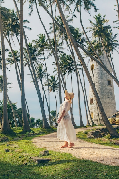 Girl in sri lanka on an island with a lighthouse.