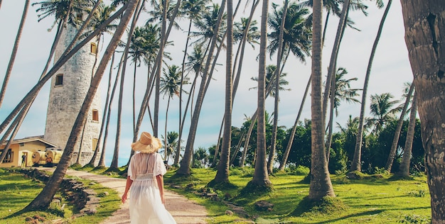 Girl in Sri Lanka on an island with a lighthouse