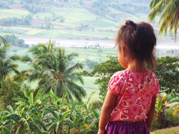 Girl standing against land