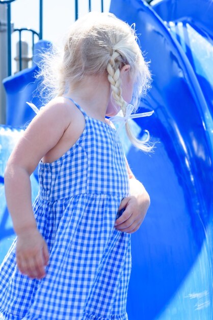 Girl standing against slide