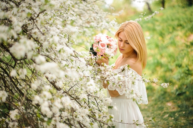 Girl standing between branches of bright white tree