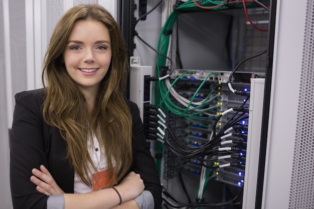 Photo girl standing in front of rack mounted servers