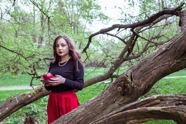 Girl standing near a tree trunk