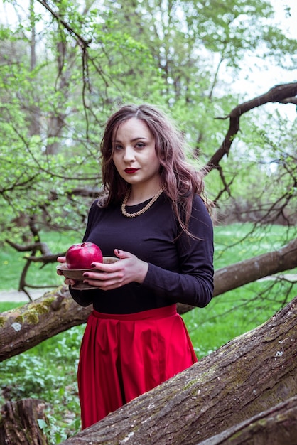 Girl standing near a tree trunk