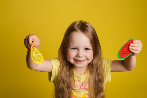 girl standing on yellow background and closing eyes