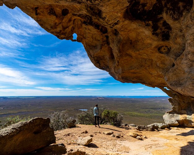 A girl stands in a cave on frenchman peak in cape le grand\
national park in western australia