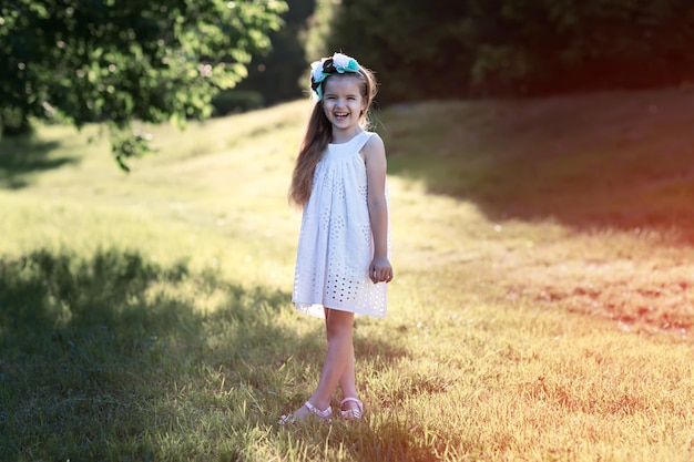 Girl stands on grass and laughing