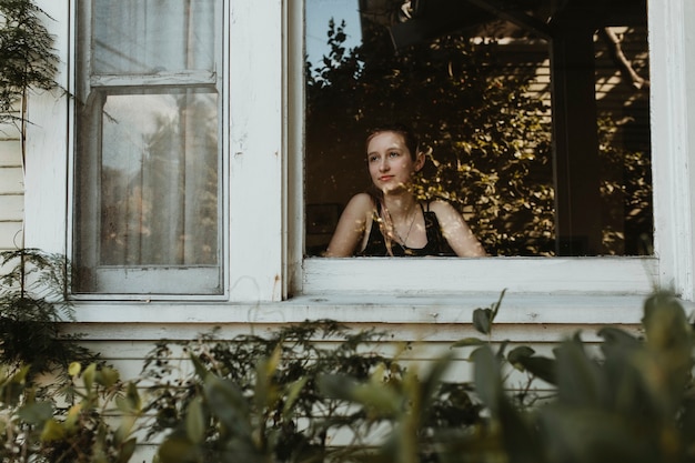 Girl staring out the window during a lockdown.