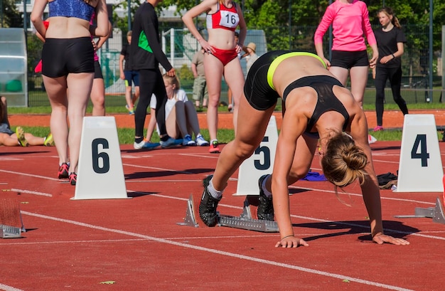 The girl at the start the stadium of the track the start