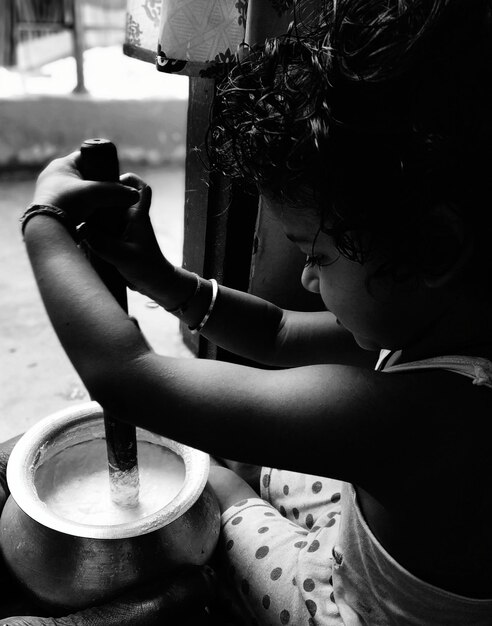 girl stirring drink in container