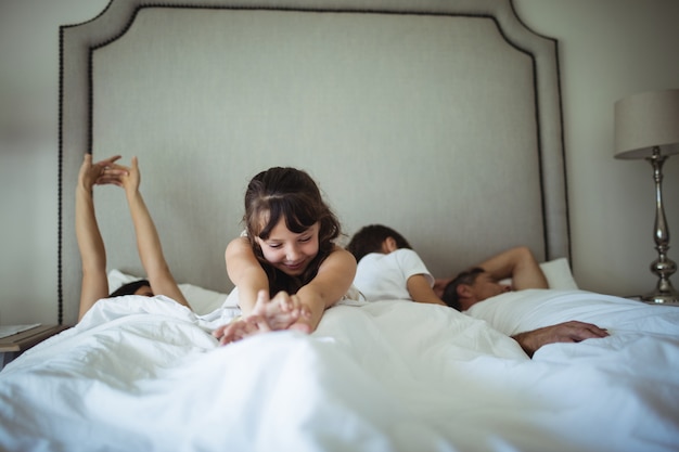 Girl stretching her arms in bed