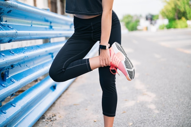 Girl stretching leg before jogging