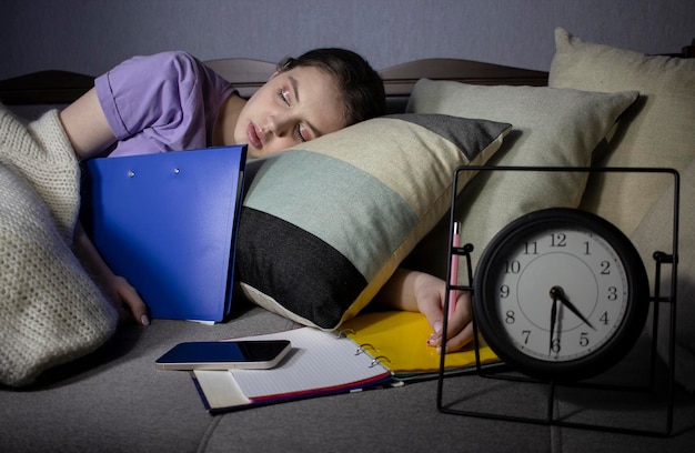 girl student fell asleep while doing homework