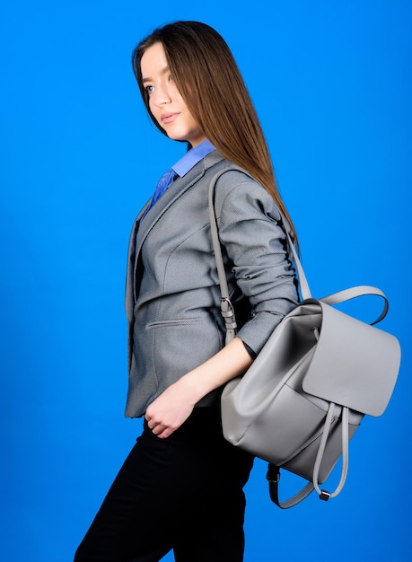 Girl student in formal clothes. Backpack fashion trend. Woman with leather knapsack. Stylish woman in jacket with leather backpack. Formal style accessories. Backpack for daily modern urban life.