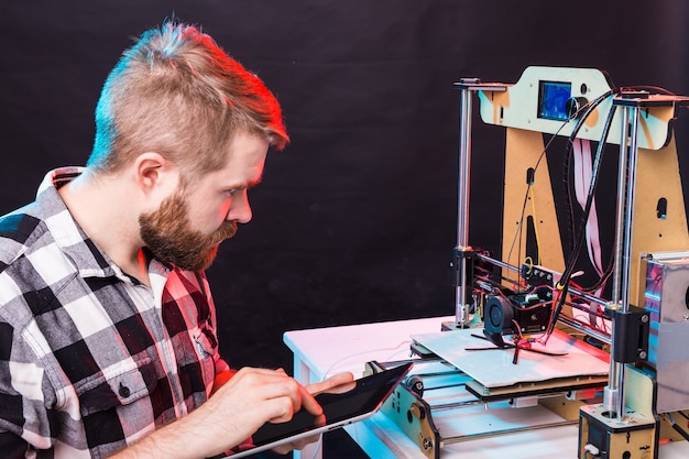 Girl student makes the item on the 3D printer