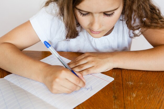 Photo girl student school teaches lessons, tasks for school, school