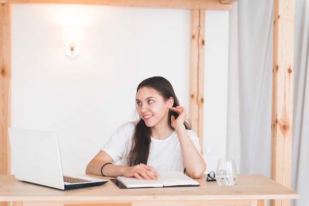 girl student sit at the table with laptop