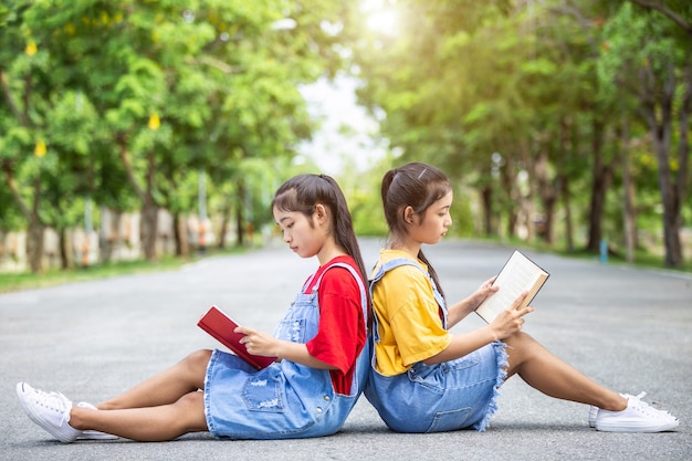 Girl or students reading a book in the park