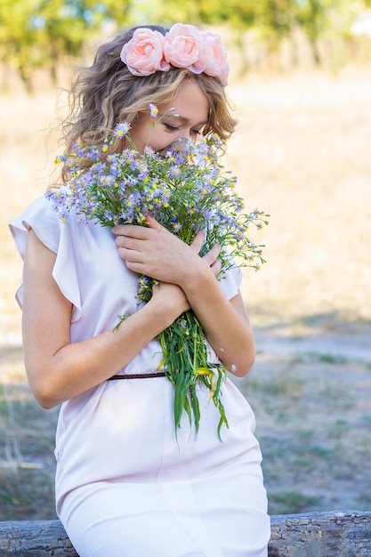 Girl in a summer dress with flowers Summer