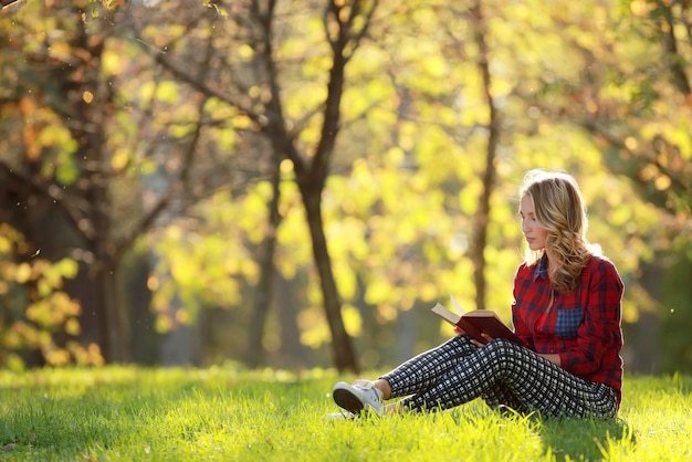 girl in a sunny park reading a book