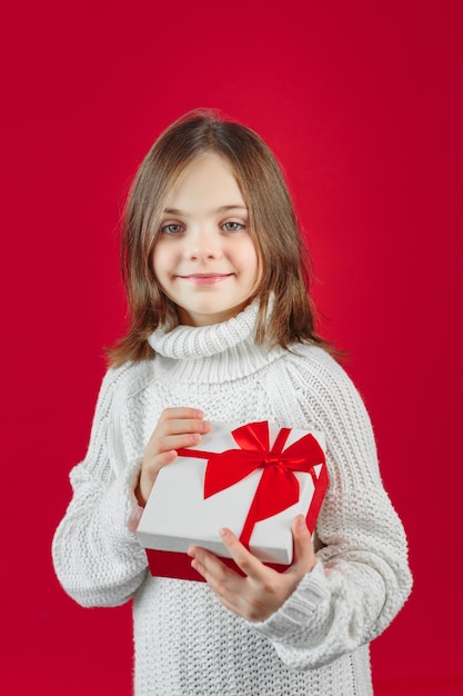 Girl in sweater gives a present