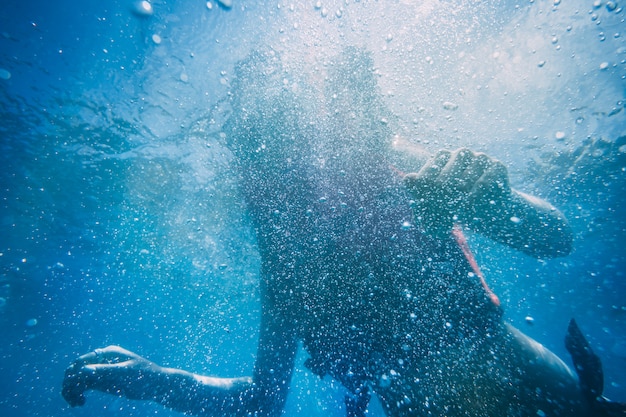 Girl swimming in ocean. underwater view