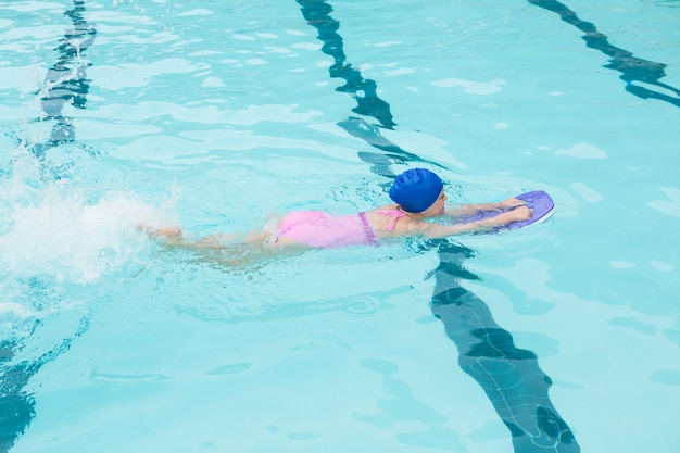 Girl swimming in the pool at the leisure center