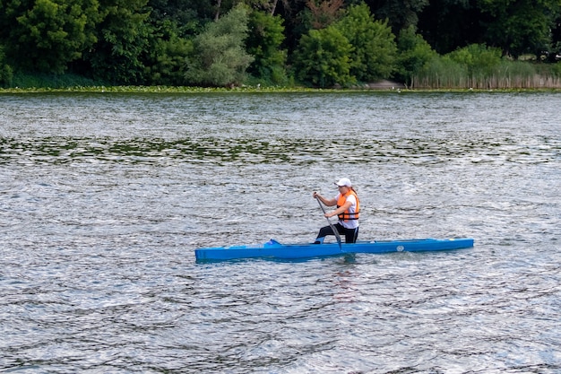 The girl swims in a canoe