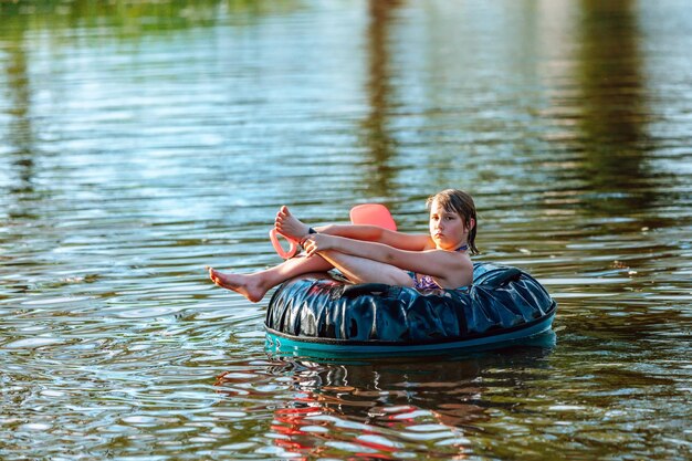 Girl swims in an inflatable circle soft focus