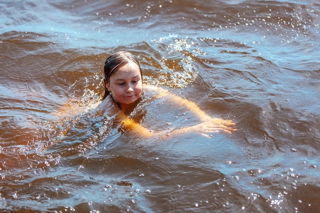 Girl swims in the water