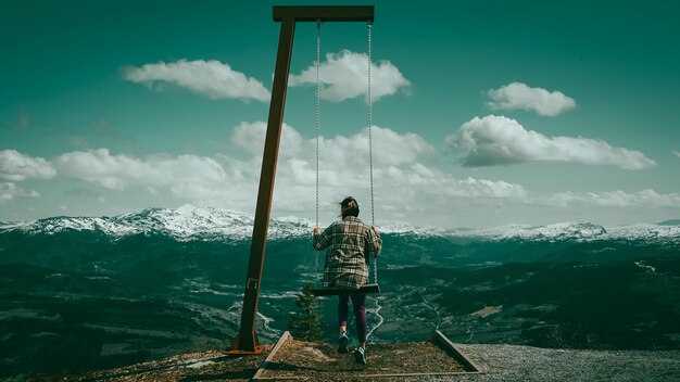 girl on a swing in the mountains Winter in the mountains in Norway