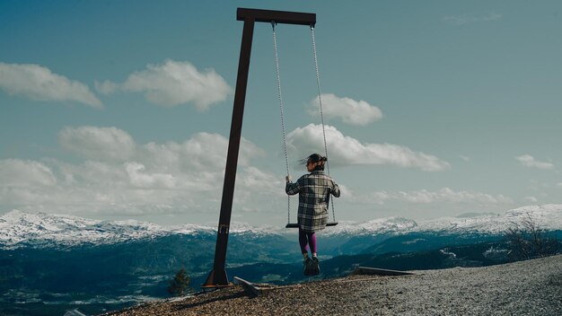 girl on a swing in the mountains Winter in the mountains in Norway