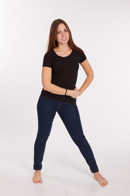 Girl in t-shirt and jeans on the white background
